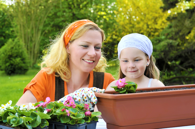 mother and daughter planting in container