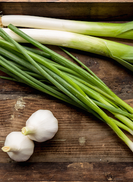 onion garlic and leek on a table